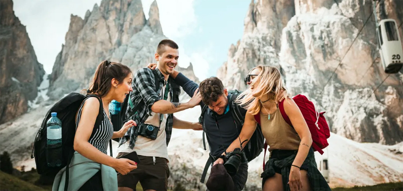 Four digital nomads as friends on a hike