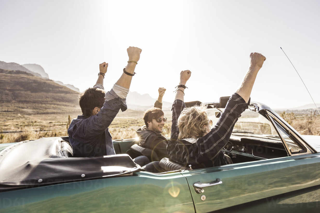 Friends on a road trip in a convertible car
